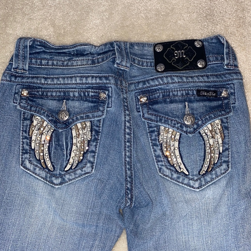 Miss Me ankle skinny jeans with angel wing pockets.